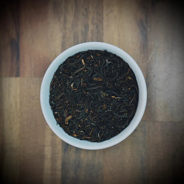 Loose leaf English Breakfast artisan tea by Little Farm Town Coffees in a 3oz package, showcasing dark tea leaves for a robust brew.