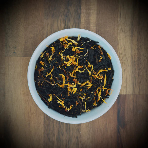 Loose leaf Mango Moments artisan tea by Little Farm Town Coffees, vibrant orange mango-flavored tea leaves in a clear jar